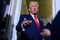 U.S. President Donald Trump speaks to members of the media on board Air Force One en route to the U.S., October 30, 2025. REUTERS/Evelyn Hockstein