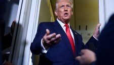U.S. President Donald Trump speaks to members of the media on board Air Force One en route to the U.S., October 30, 2025. REUTERS/Evelyn Hockstein