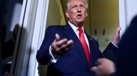 U.S. President Donald Trump speaks to members of the media on board Air Force One en route to the U.S., October 30, 2025. REUTERS/Evelyn Hockstein