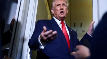 U.S. President Donald Trump speaks to members of the media on board Air Force One en route to the U.S., October 30, 2025. REUTERS/Evelyn Hockstein